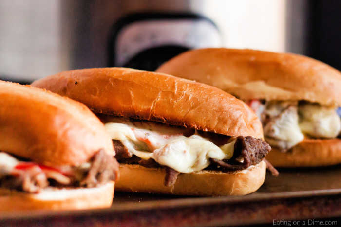 Close up image of philly cheesesteak on a baking sheet. 