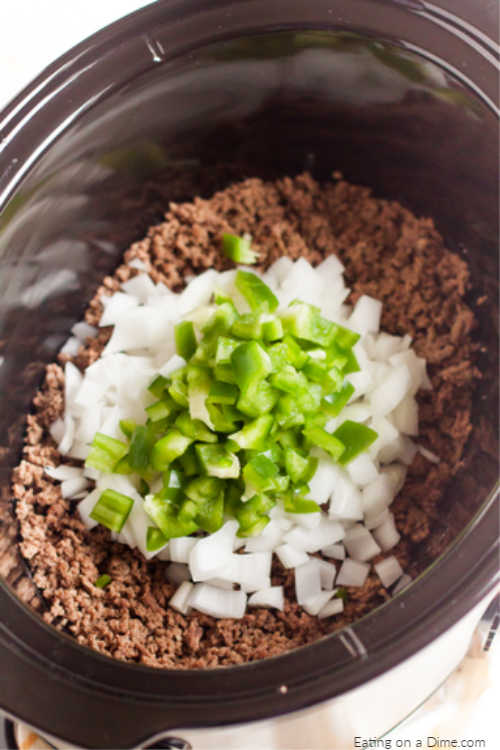 Placing the ground beef and vegetables in the slow cooker