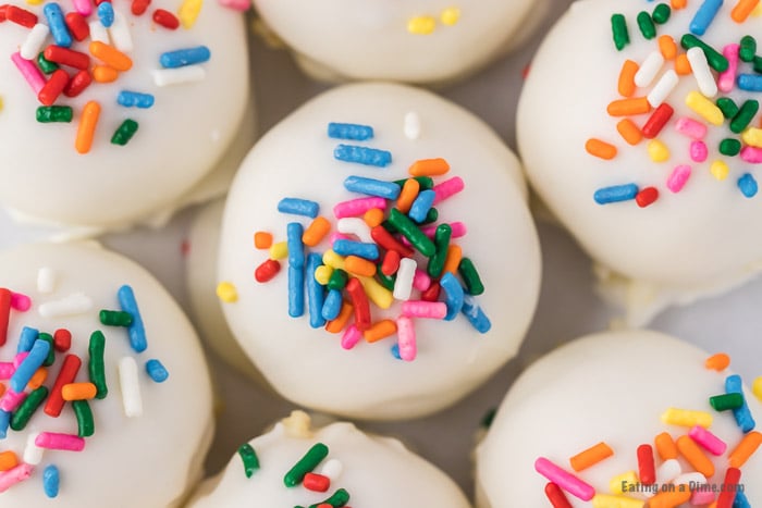 If you need a simple yet tasty dessert, try Easy Cake Ball Recipe. It is the perfect dessert for parties, holidays and more but easy enough to make anytime! Cake balls with sprinkles close up photo