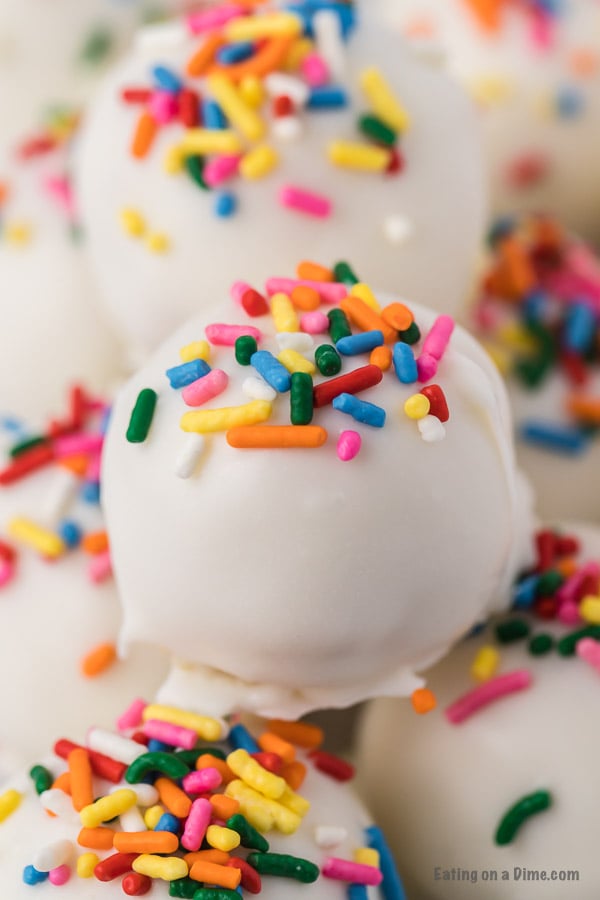 If you need a simple yet tasty dessert, try Easy Cake Ball Recipe. It is the perfect dessert for parties, holidays and more but easy enough to make anytime! Cake balls with sprinkles close up photo