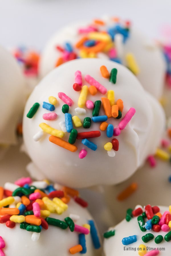 If you need a simple yet tasty dessert, try Easy Cake Ball Recipe. It is the perfect dessert for parties, holidays and more but easy enough to make anytime! Cake balls with sprinkles close up photo