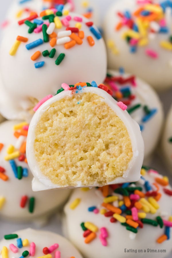 If you need a simple yet tasty dessert, try Easy Cake Ball Recipe. It is the perfect dessert for parties, holidays and more but easy enough to make anytime! Cake balls with sprinkles close up photo