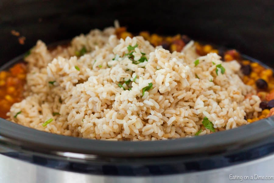 Brown Rice topped chicken burrito ingredients in the crock pot