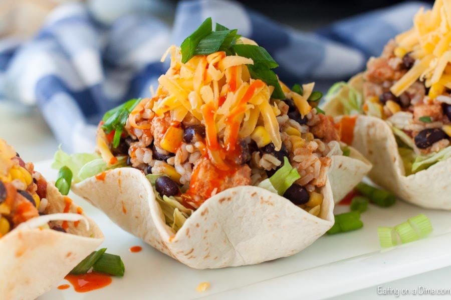 Chicken Burrito Bowl in a flour tortilla topped with chicken and green onions