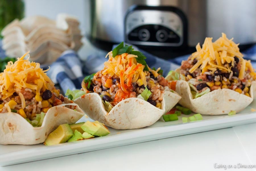 Chicken Burrito Bowl in a flour tortilla topped with chicken and green onions