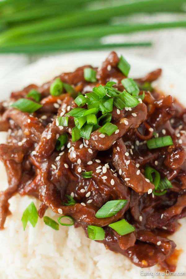 Close up image of Mongolian Beef with green onions on top.