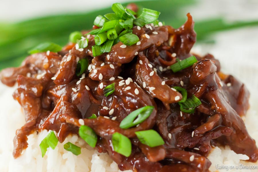 Close up image of Mongolian Beef with green onions on top.