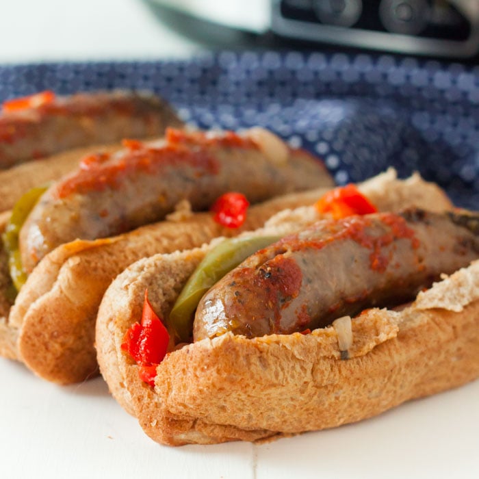 Close up image of italian sausage and peppers in a hoagie