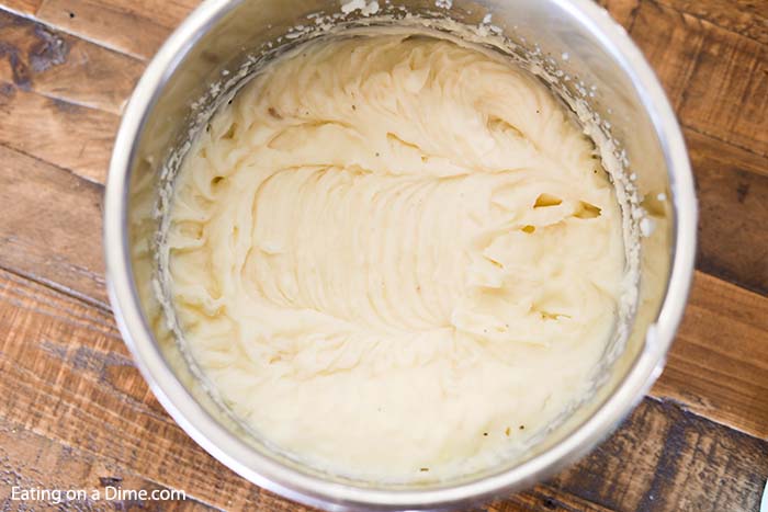 Close up image of mashed potatoes in the instant pot just after being mixed. 