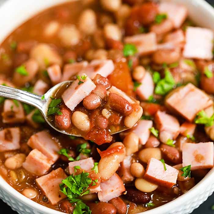 Crock Pot 15 Bean Soup with ham is so frugal and a great way to feed a crowd. The soup is so delicious and packed with flavor that everyone will want more.