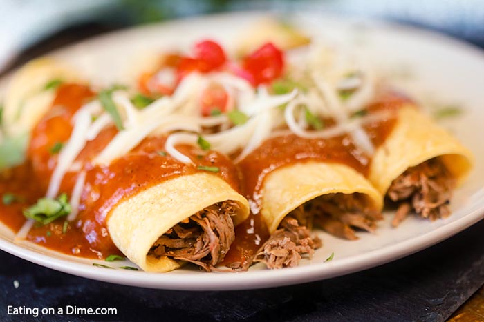 Slow Cooker Shredded Beef Enchiladas Recipe comes together with very little work but amazing taste. The crock pot does all of the work.