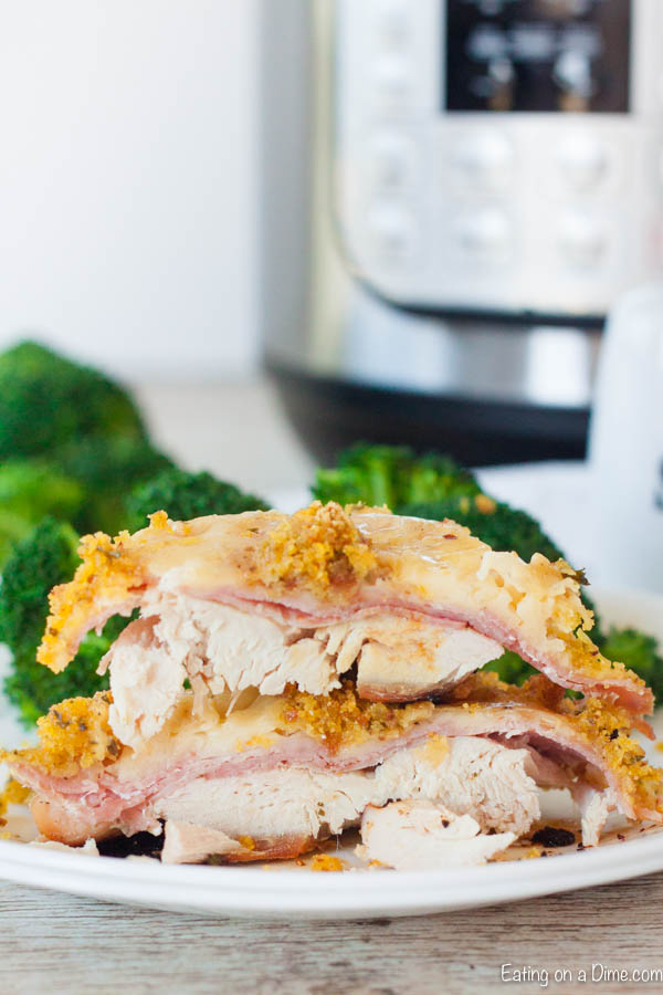 Chicken Cordon Bleu on a plate with a side of broccoli with an instant pot in the background