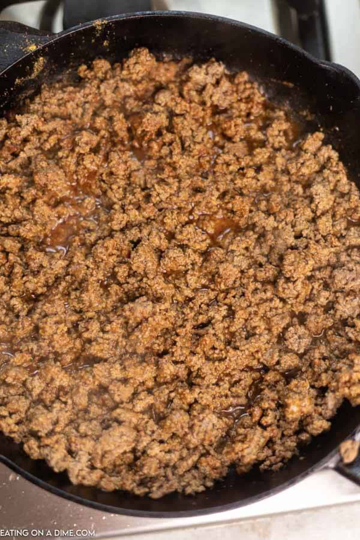 The ground beef browned and seasoning with the salsa and the taco seasoning in a cast iron skillet. 