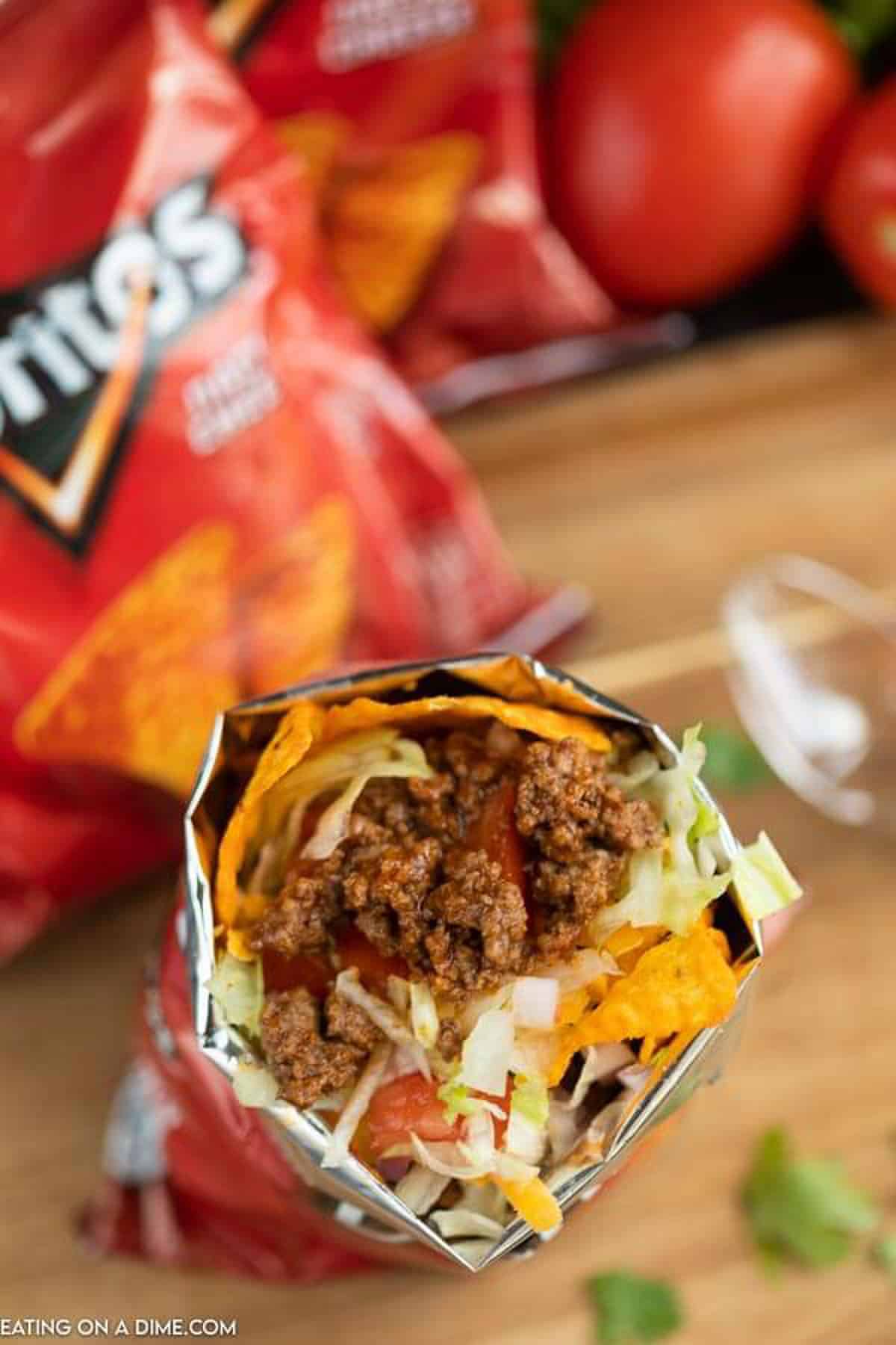 Overview of the top of a walking taco with extra bags of Doritos behind it. 