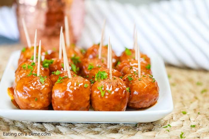 Buffalo Chicken Meatballs with toothpicks in them on a white platter