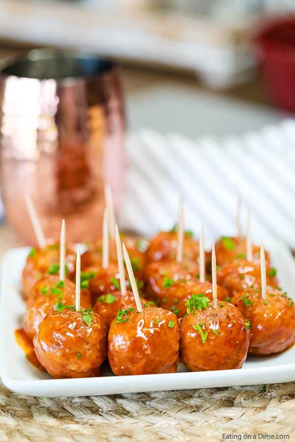 Buffalo Chicken Meatballs with toothpicks in them on a white platter