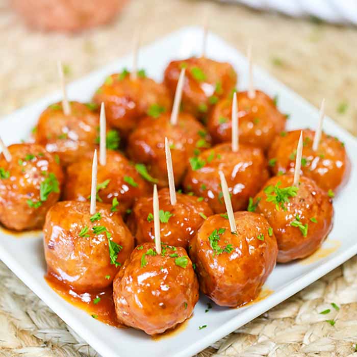 Buffalo Chicken Meatballs with toothpicks in them on a white platter