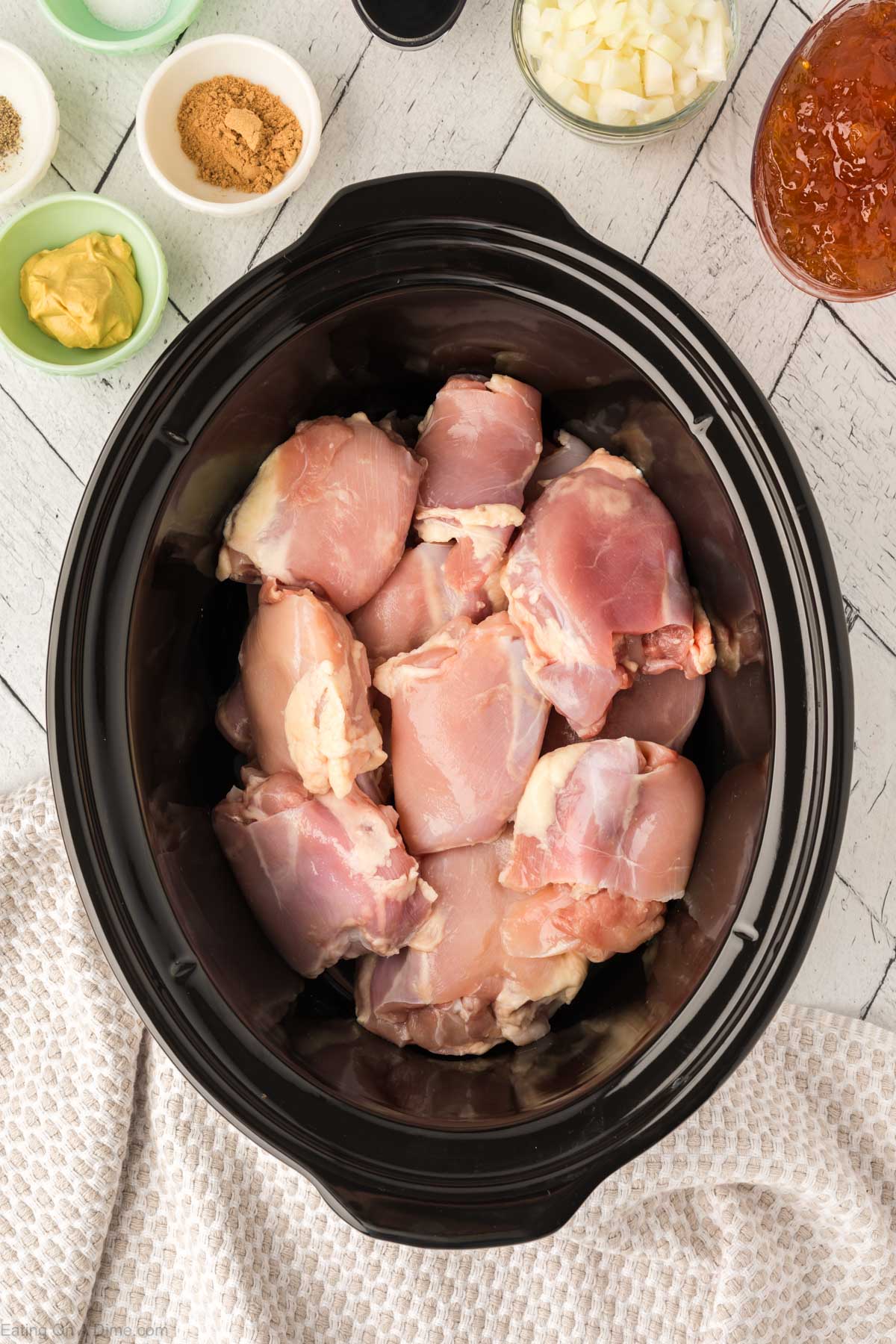 Placing the chicken thighs in the slow cooker