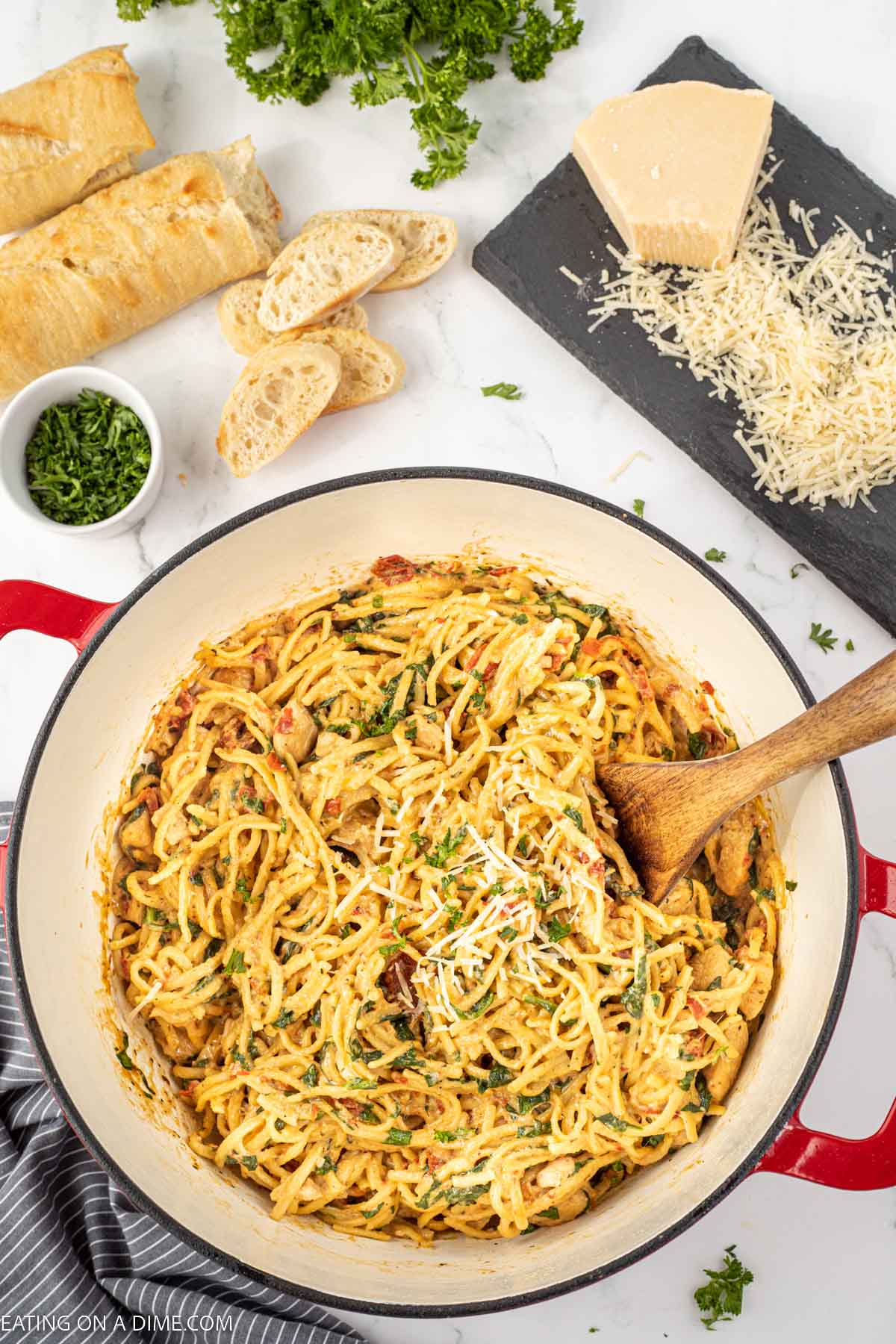 Italian Chicken Pasta in a large pot with a wooden spoon