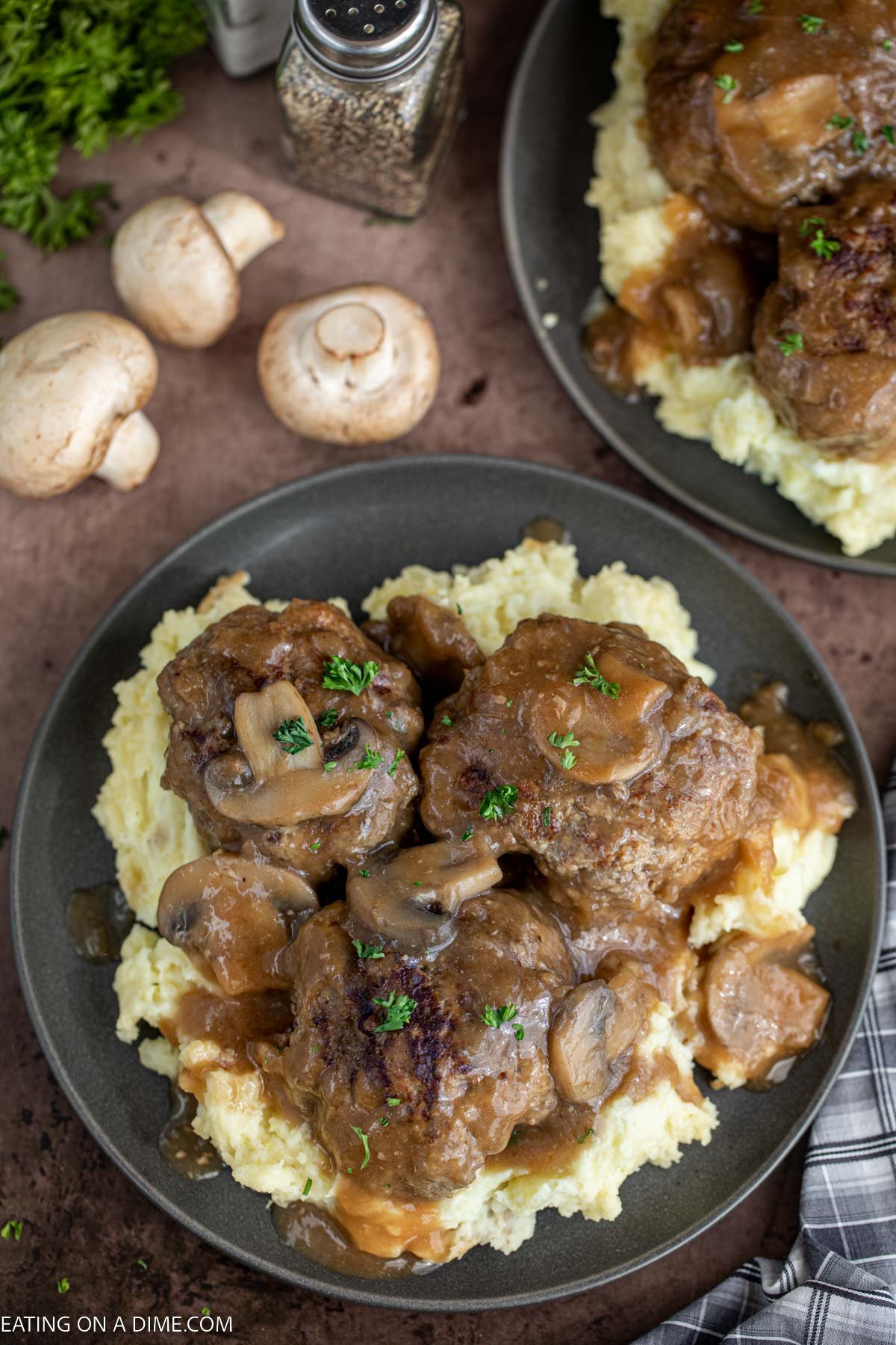 Salisbury Steak over mashed potatoes on a plate