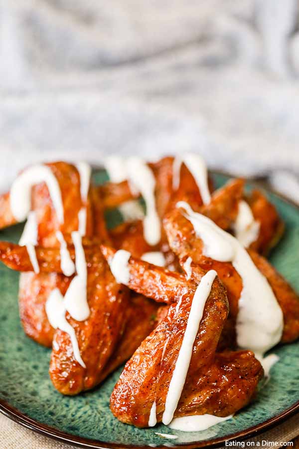 Air fryer recipes chicken wings are easy to make and turn out crispy and delicious. These air fryer chicken wings are healthy, extra crispy and are the best! Also, included are 3 sauce recipes including buffalo, BBQ and garlic parmesan. These are great on a Keto diet too! #eatingonadime #airfryerrecipes #chickenwingsrecipes 
