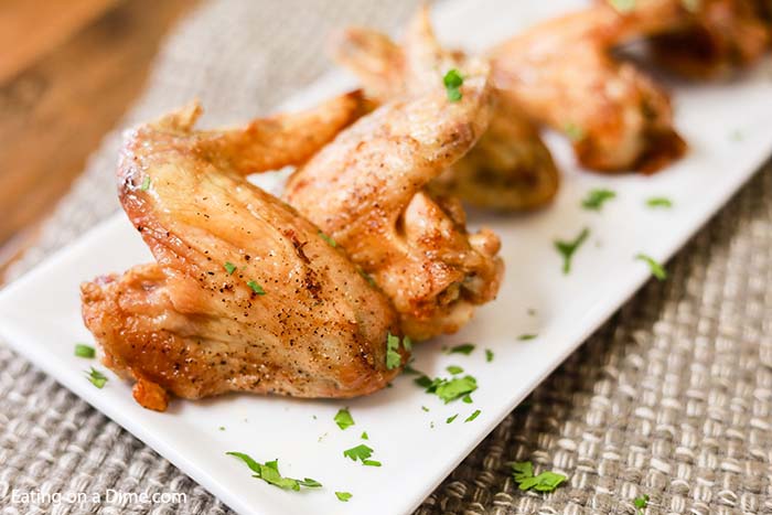 Air fryer recipes chicken wings are easy to make and turn out crispy and delicious. These air fryer chicken wings are healthy, extra crispy and are the best! Also, included are 3 sauce recipes including buffalo, BBQ and garlic parmesan. These are great on a Keto diet too! #eatingonadime #airfryerrecipes #chickenwingsrecipes 