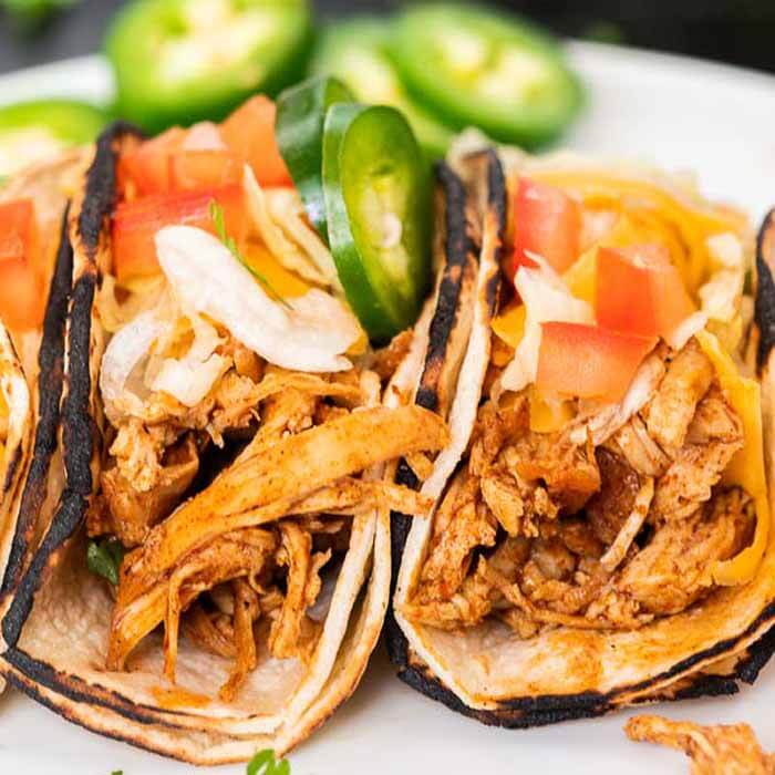 You're going to love this healthy instant pot chicken tacos. This is one of my favorite pressure cooker recipes. This 3 ingredient shredded electric pressure cooker chicken tacos with salsa and taco seasoning is easy to make! You can even make chicken tacos from frozen with this easy recipe that is truly the best! This instant pot recipes easy chicken is perfect for tacos and taco bowls! The entire family will love it! #eatingonadime #instantpotrecipes #pressurecookerrecipes #chickentacos #shreddedchickentacos 