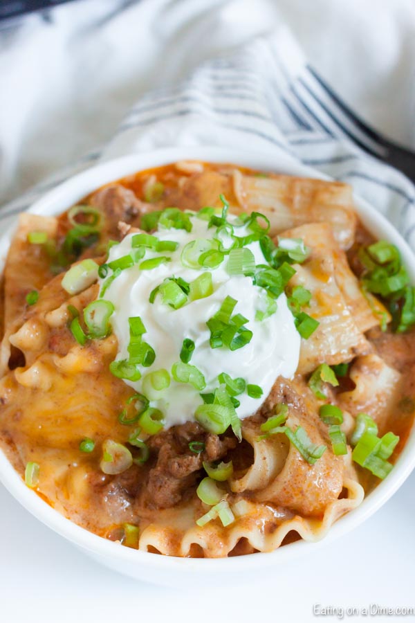 Crock Pot Mexican Lasagna Recipe has layers of delicious cheese, refried beans, beef and more for the best dinner. Let the crockpot do all the work! 