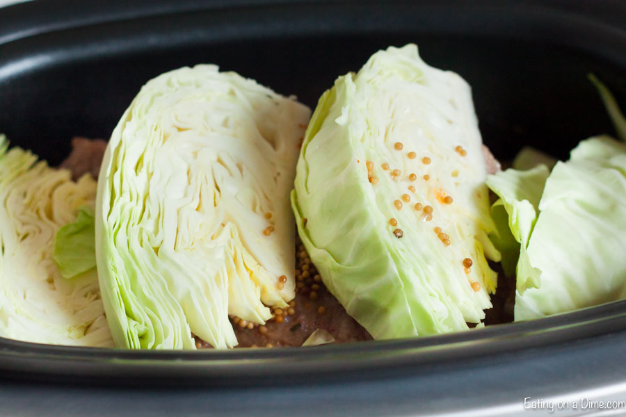 The cabbage being added to the crock pot.  