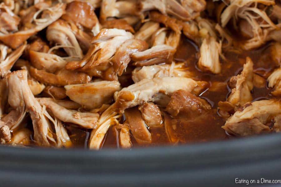 Close up image of chicken in the chow mein sauce in the crock pot. 