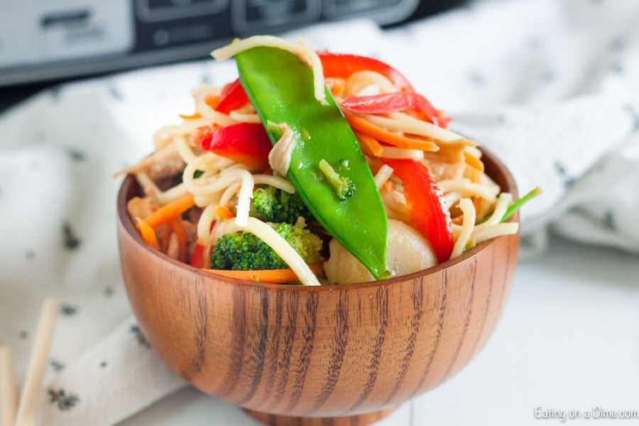 Close up image of a Chicken Chow Mein in a brown bowl.
