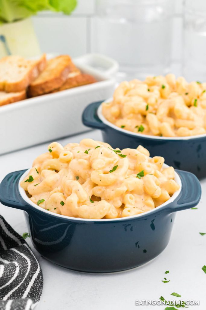 Close up image of blue bowls of macaroni and cheese