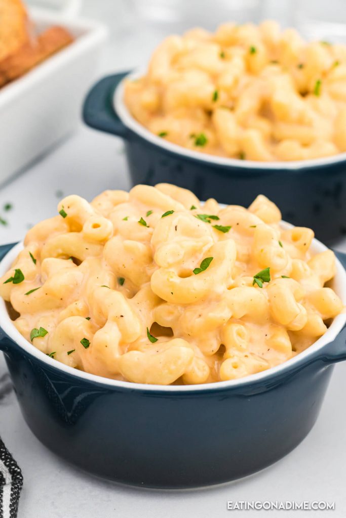 Close up image of blue bowls of macaroni and cheese