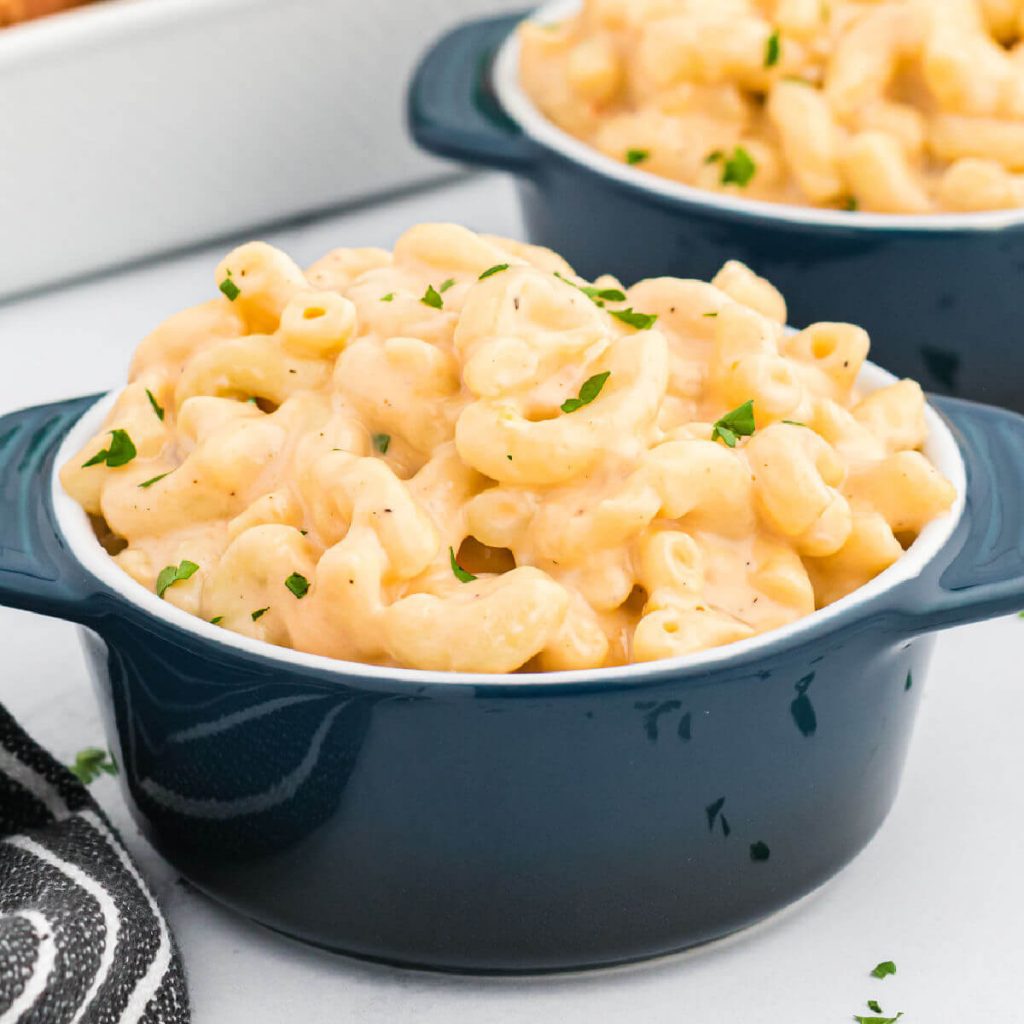 Close up image of blue bowls of macaroni and cheese