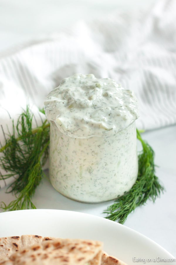 Close up image of a jar of Tzatziki Sauce. 