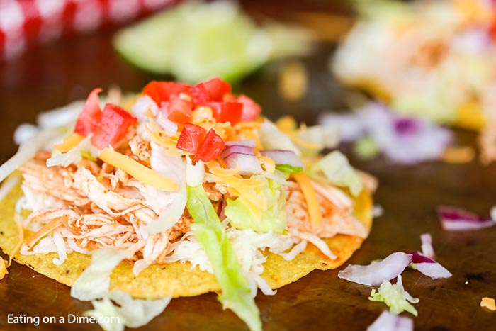 Crock pot chicken tostadas recipe gets dinner on the table fast for a great meal. This recipe is versatile and works for family dinner, parties and more. 