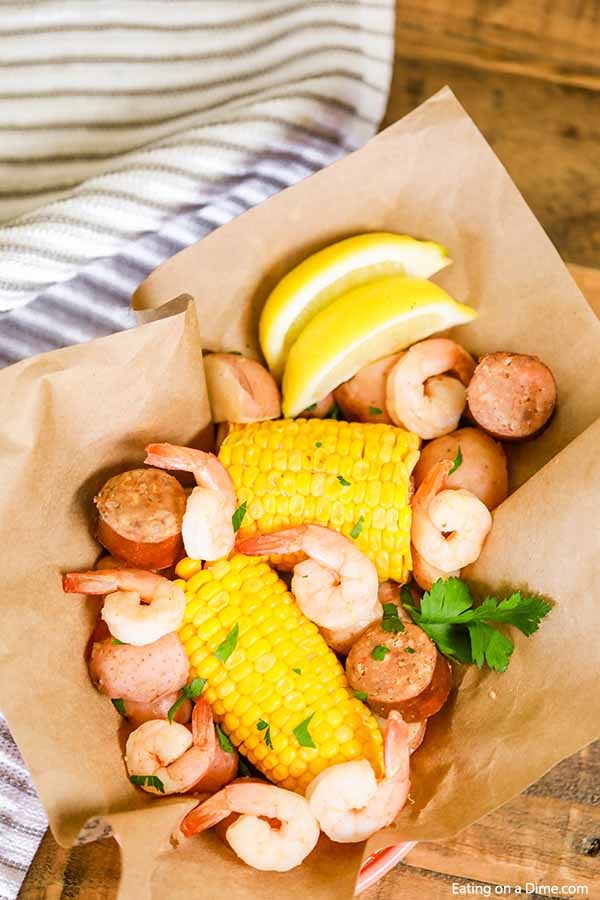 Shrimp, corn and more come together for a meal everyone will love in this Crock Pot Shrimp Boil Recipe. This slow cooker shrimp boil is a must try!