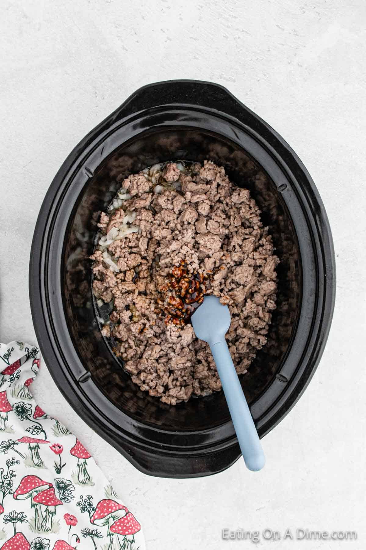 Adding the sauce ingredients to the slow cooker