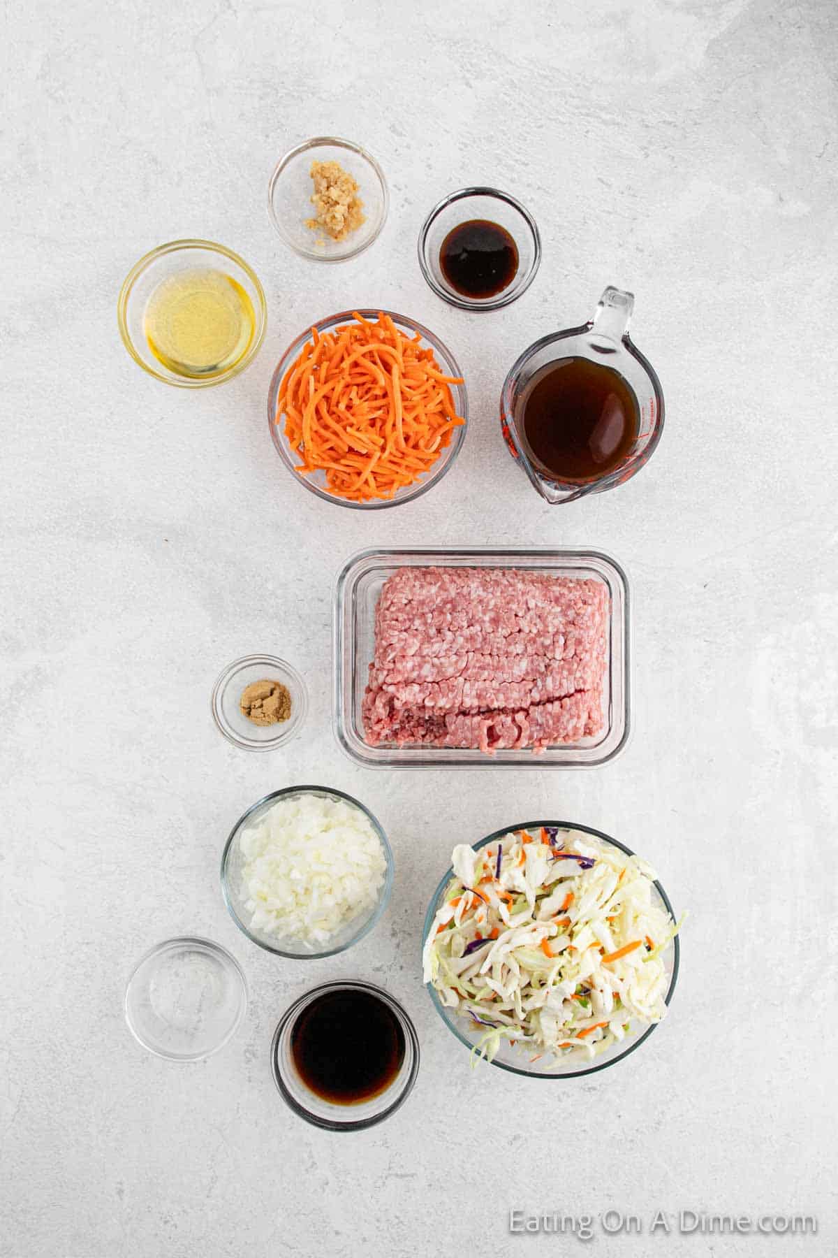 Egg Roll in a Bowl Ingredients - Ground Pork, Onion, Chicken Broth, garlic, sesame oil, rice vinegar, ginger, soy sauce, hoisin sauce, coleslaw mix, carrots, green onions