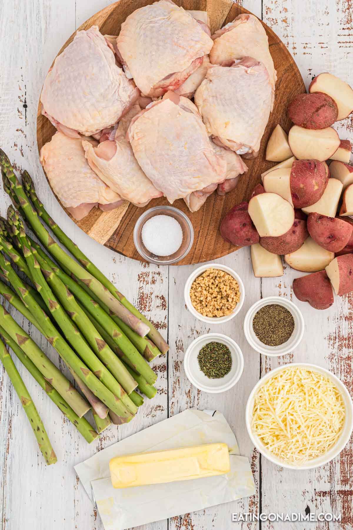 Ingredients needed - chicken thighs, salt and pepper, minced garlic, dried thyme, butter, red potatoes, fresh asparagus, parmesan cheese
