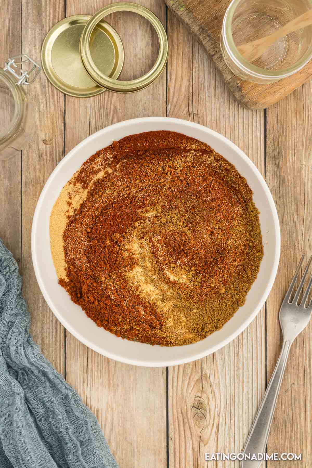 Fajita seasoning being mixed in a white bowl