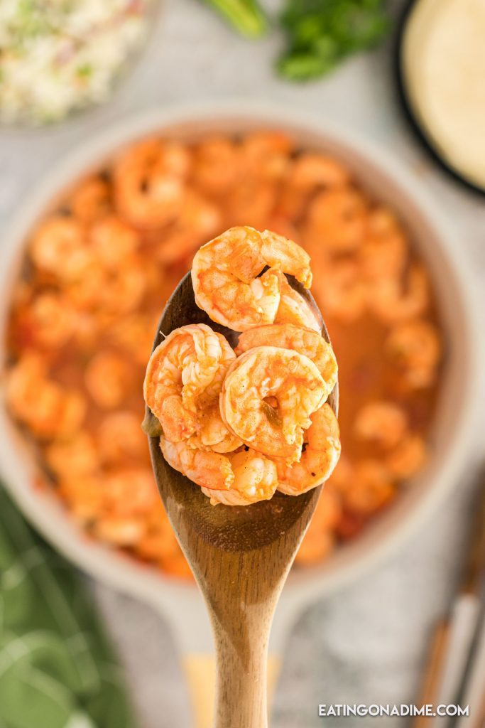 Seasoned shrimp on a wooden spoon