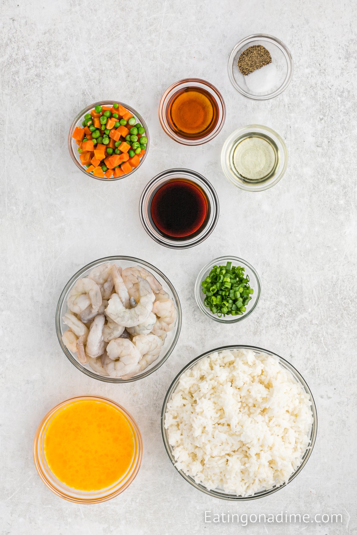 Ingredients needed - shrimp, eggs, sesame oil, vegetable oil, rice, soy sauce, salt and pepper, peas and diced carrots, green onions