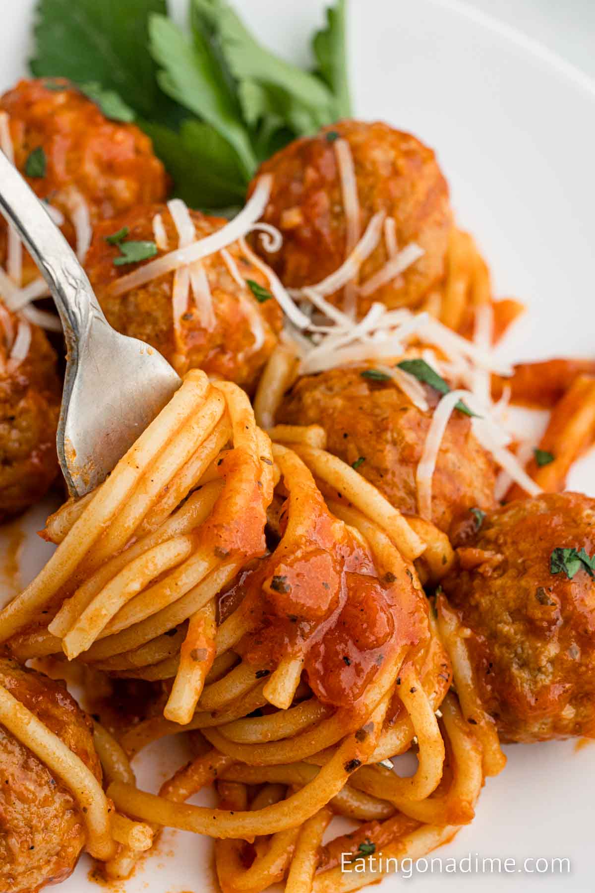 Spaghetti and Meatballs on a plate with a side of salad