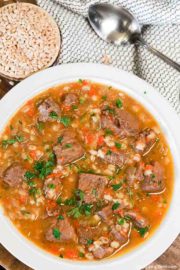 Crockpot beef barley soup is a filling meal perfect for hearty appetites. Lots of tender beef, potatoes and vegetables make this a tasty meal that is easy in crockpot. Homemade beef barley soup is the best ever vegetable slow cooker soup. Try this healthy crock pot recipe. #eatingonadime #crockpotbeefbarleysoup #easyrecipes #slowcooker
