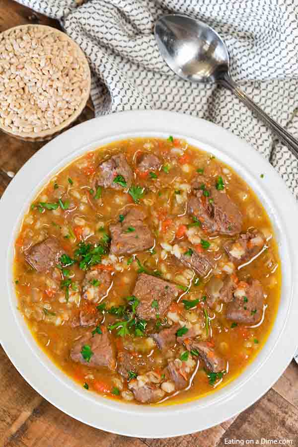 Crockpot beef barley soup is a filling meal perfect for hearty appetites. Lots of tender beef, potatoes and vegetables make this a tasty meal that is easy in crockpot. Homemade beef barley soup is the best ever vegetable slow cooker soup. Try this healthy crock pot recipe. #eatingonadime #crockpotbeefbarleysoup #easyrecipes #slowcooker