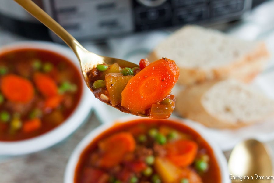 A serving of ground beef stew on a spoon