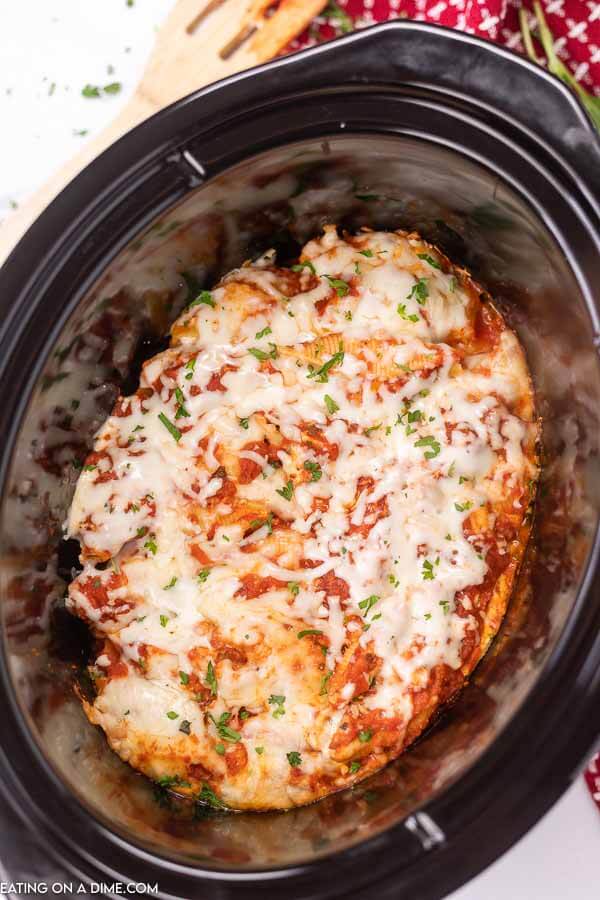 Make dinner simple when you make Crockpot stuffed shells recipe. The shells are stuffed with a delicious cheesy filling and the slow cooker does all the work. This easy stuffed shells recipe is the best homemade Italian meal. Try making this classic cheese stuffed recipe with ricotta. #eatingonadime #crockpotstuffedshells #stuffedshellsrecipeeasy #ComfortFoods #RicottaEasy #EasyCheese #stuffedshellsrecipericotta #jumbo #large #dinners 