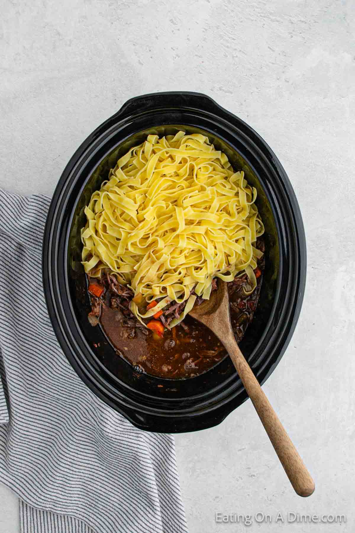 Mixing the cooked pasta in the beef mixture