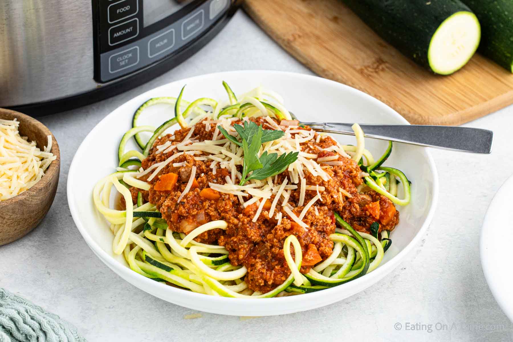 Bolognese Sauce over zoodles in a white bowl